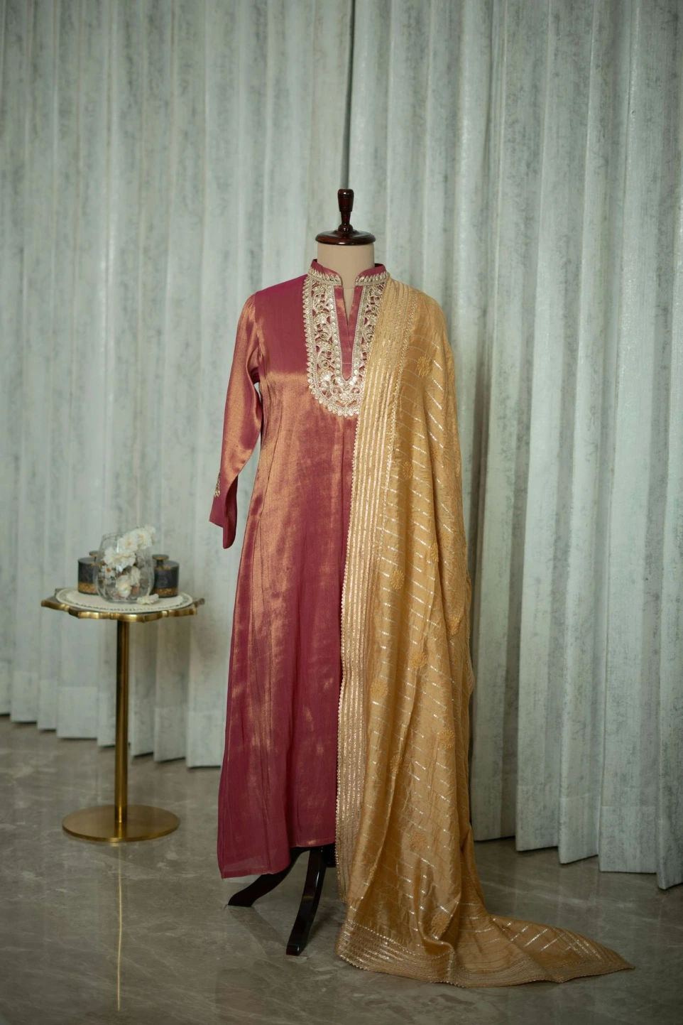 A mannequin dressed in a red and gold outfit